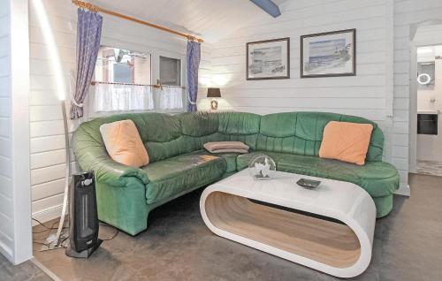 a living room with a green couch and a table at Ferienhaus Dabel in Dabel