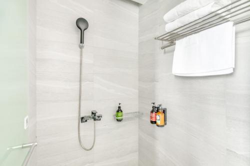 a shower in a bathroom with a shower head at Jhai Wu in Kenting