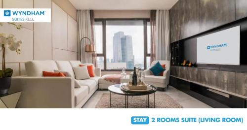 a living room with a couch and a tv at Wyndham Suites KLCC in Kuala Lumpur