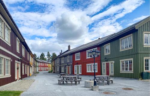 a row of colorful buildings with picnic tables in the street at Nice Apartment In Bjorli With Wifi in Bjorli
