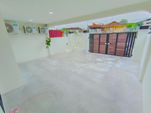 an empty room with a concrete floor and a gate at Skudai Tun Aminah Cozy Home - Sutera Mall 6 mins in Skudai