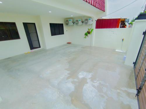 an empty room with a concrete floor in a house at Skudai Tun Aminah Cozy Home - Sutera Mall 6 mins in Skudai