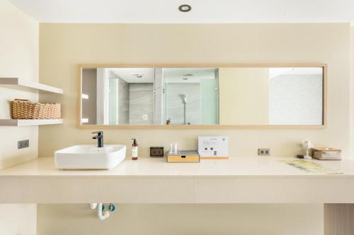 a bathroom with a sink and a mirror at Jhai Wu in Kenting