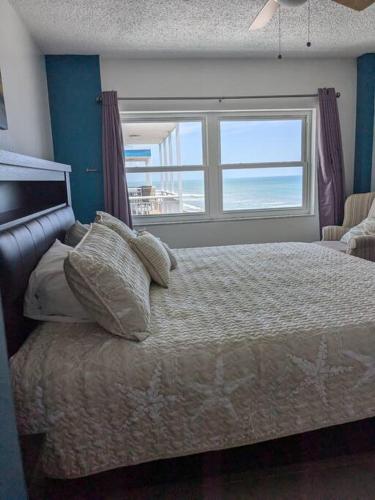 a bedroom with a bed with a view of the ocean at Oceanfront 2Br-2B in Satellite Beach - Ocean Views in Satellite Beach