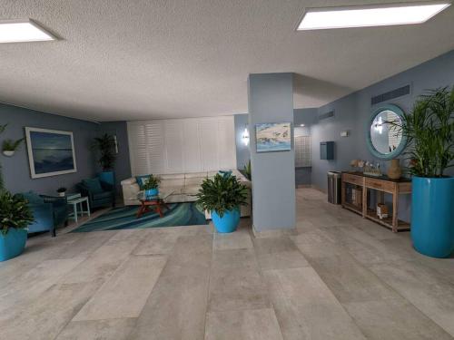 a large living room with potted plants in it at Oceanfront 2Br-2B in Satellite Beach - Ocean Views in Satellite Beach