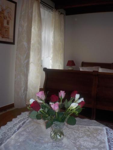 a vase of flowers on a table in a bedroom at Hotel Kriváň in Kysucké Nové Mesto