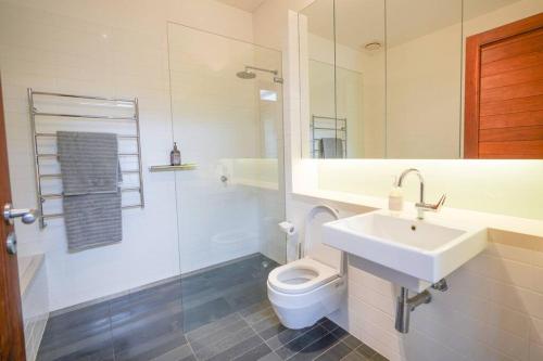 a white bathroom with a sink and a toilet at Redbank Estate - Luxury in Scone in Scone