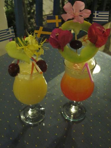 two vases with flowers in them on a table at Nefeli Hotel in Myrties