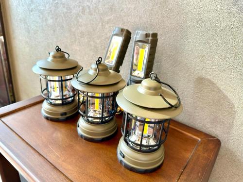 a group of lanterns on a table with a cell phone at 伊東山荘-Toki- in Ito