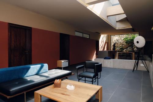 a living room with a couch and a table at MUUA Hotel in Wushan