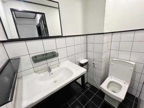 a bathroom with a sink and a toilet at Years 1981 in Bangkok