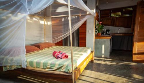 Ένα ή περισσότερα κρεβάτια σε δωμάτιο στο Casa Paraiso Mazunte