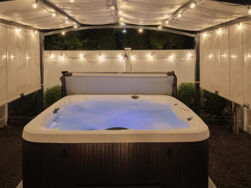 a jacuzzi tub in a tent with lights at The Lambertville Haven in Lambertville