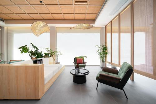 a living room with a couch and a chair at Constellation XingSu Boutique Hotel in Huangshan