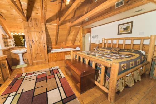 a bedroom with a bed and a tub in a room at Bears Lair cabin Chalet in Sevierville