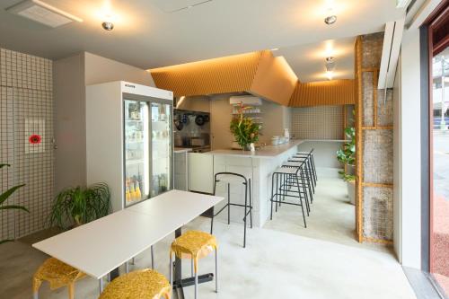 a kitchen with tables and stools in a room at SHORTsuido in Tokyo