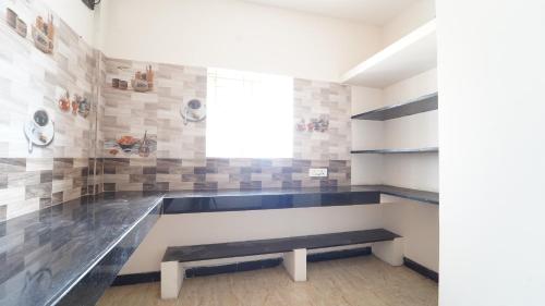 a room with a bench and a window at Nini Residency codissia stay in Coimbatore