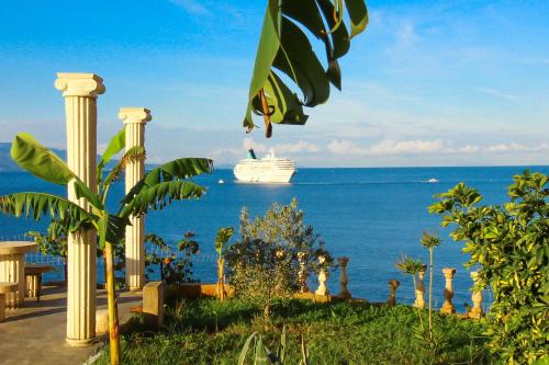 a cruise ship in the ocean with a cruise ship at Apartments Romario in Sarandë