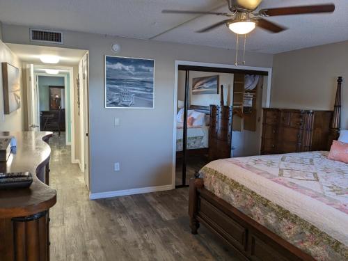 a bedroom with a bed and a ceiling fan at Ocean Front by Cocoa Beach Pier in Cocoa Beach