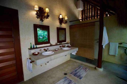 a bathroom with two sinks and a shower at Casa Los Cocoteros in Gallinero