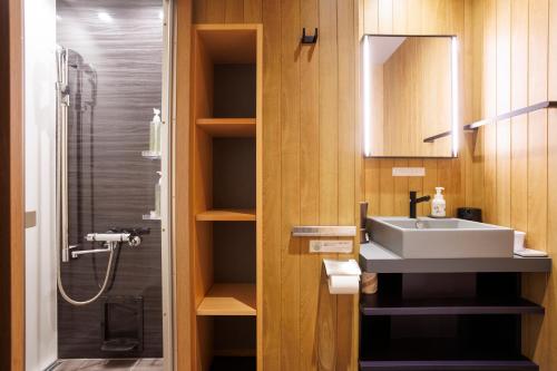a bathroom with a sink and a shower at Hotel Ethnography Kiyomizu Gojo in Kyoto