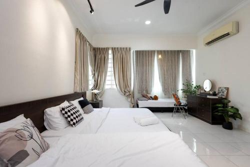 a white bedroom with a large bed and a desk at Retro Homestay Ipoh - Semi D 15pax Wedding in Ipoh