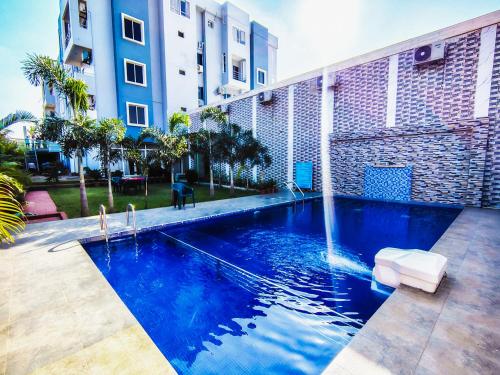 a swimming pool in front of a building at Grand Resort in Puri