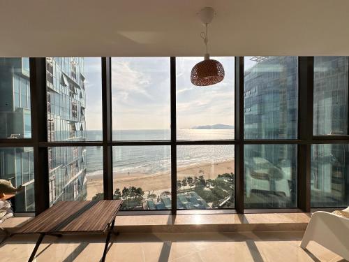 a room with a view of the beach from a building at Haeundae Luxury House in Busan