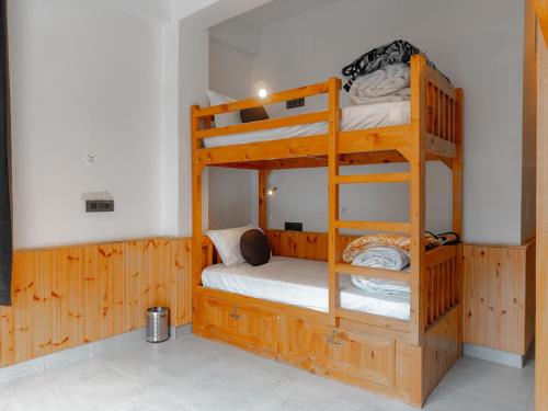 a bunk bed room with two bunk beds in it at The Rustic Jibhi - Backpackers Hostel in Jibhi