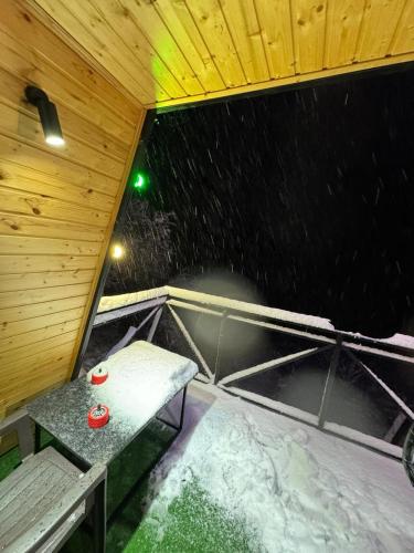 a sauna with a bench and a table in the rain at Paradise Keda in Keda