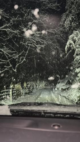 a car windshield with snow on the glass at Paradise Keda in Keda