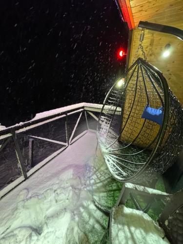 an empty swing set in the snow at night at Paradise Keda in Keda