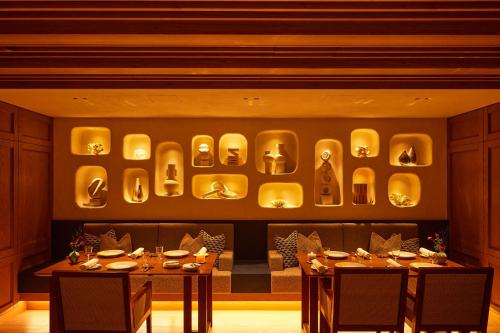 a restaurant with two tables and a display of dishes at UMITO Kamakura Koshigoe in Kamakura