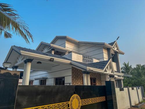 a house with a fence in front of it at 4bhk Luxury Villa in Mangalore
