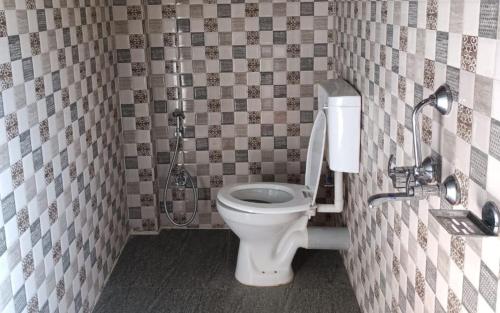 a bathroom with a toilet and a shower at The Cherry Blossom Homestay By StayApart in Takdāh