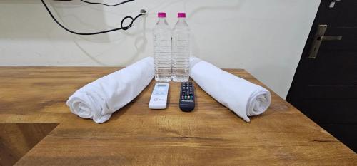 a table with two remote controls and a wii controller at Sun Residency Tvm in Tiruvannāmalai