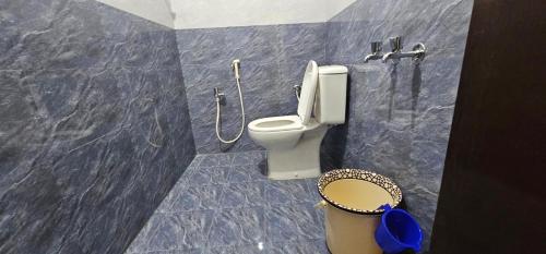 a bathroom with a toilet and a shower at Sun Residency Tvm in Tiruvannāmalai