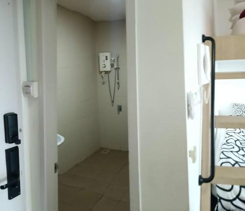 a small room with a room with a bed and a door at Spacious i-City Studio home 3 Beds by Nuriman in Shah Alam