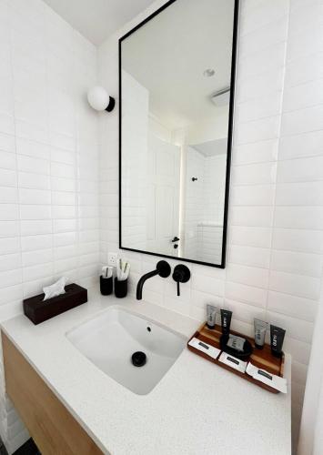 a bathroom with a white sink and a large mirror at Rio Royale in Candolim