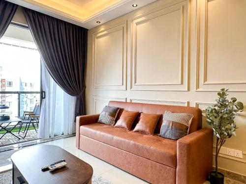 a living room with a couch and a table at R&F Princess Cove by Nest Home at Johor Bahru in Johor Bahru