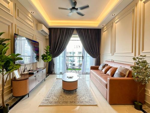 a living room with a couch and a tv at R&F Princess Cove by Nest Home at Johor Bahru in Johor Bahru