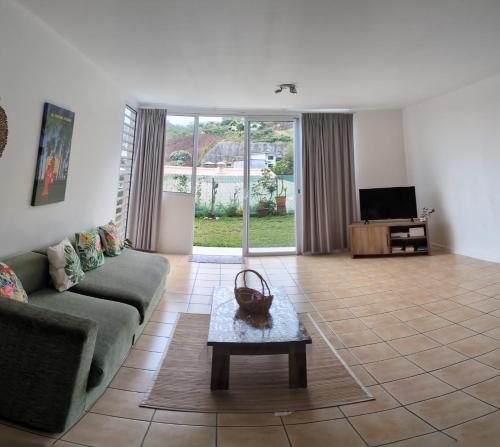 a living room with a couch and a table at N'JOK Papeete in Papeete
