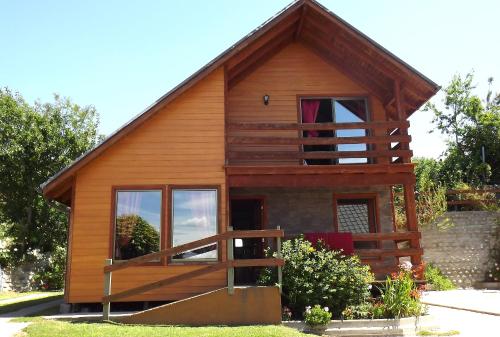 a small wooden house with a large window at Cabañas El Galo in Panguipulli