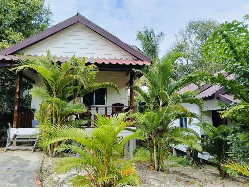 a house with palm trees in front of it at Stay in Paradise Koh Rong in Koh Rong Island