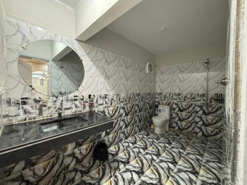 a bathroom with a sink and a mirror at Askin Heritage - in Rawalpindi