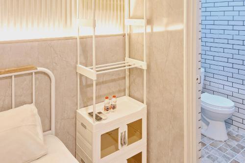 a small bathroom with a toilet and a sink at Reddoorz New Melati near Stasiun Blitar in Blitar