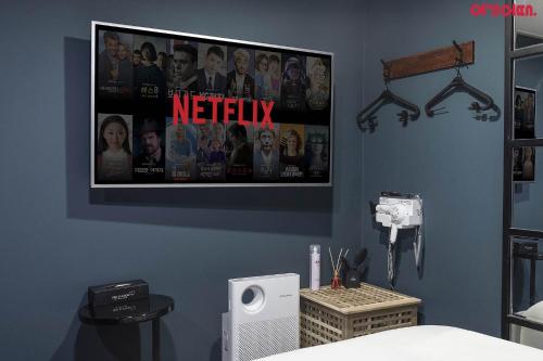 a bedroom with a netflix poster on the wall at Bed Station in Incheon