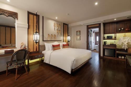 Ένα ή περισσότερα κρεβάτια σε δωμάτιο στο Akira Thaphae Hotel