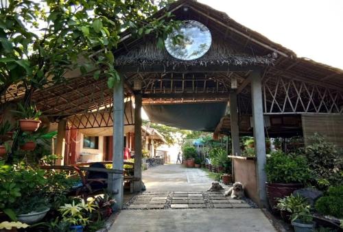 a dog sitting in front of a building with a clock at RedDoorz Hostel at Megans Paradisio Beach Resort in Zambales