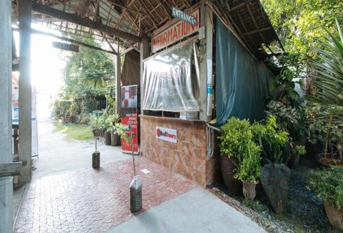 a building with a sign on the side of it at RedDoorz Hostel at Megans Paradisio Beach Resort in Zambales
